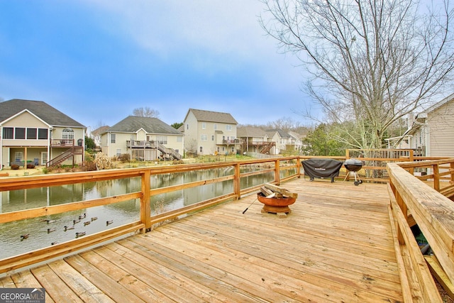 wooden deck featuring a water view