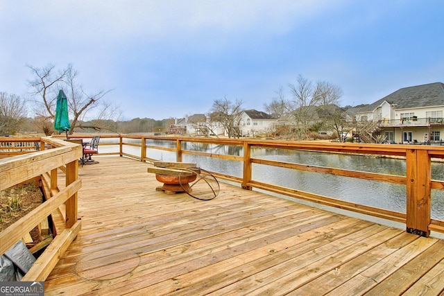 view of dock with a deck with water view