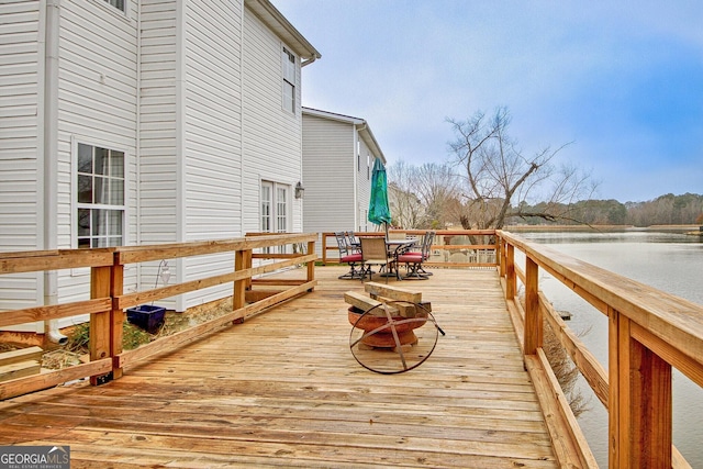 wooden deck featuring a water view