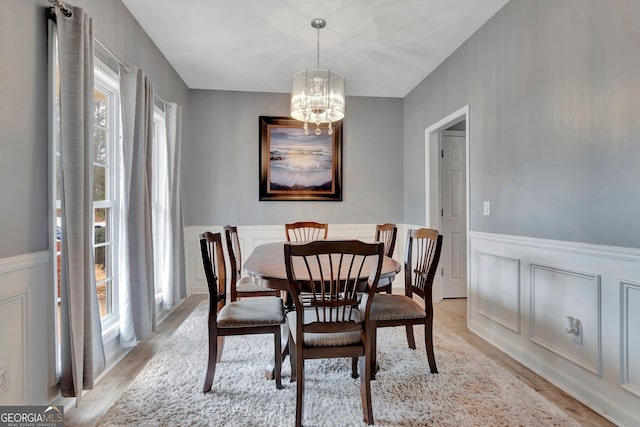 dining room featuring a chandelier, light hardwood / wood-style floors, and a wealth of natural light