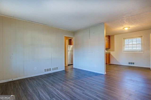 spare room with crown molding and dark hardwood / wood-style floors