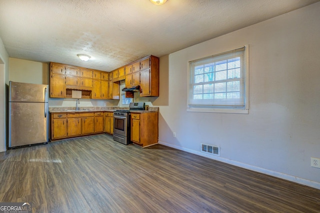 kitchen featuring dark hardwood / wood-style flooring, sink, a textured ceiling, and appliances with stainless steel finishes