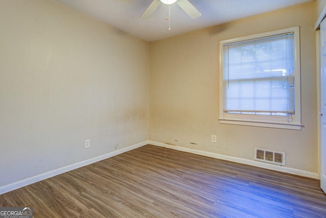 spare room featuring dark hardwood / wood-style floors and ceiling fan