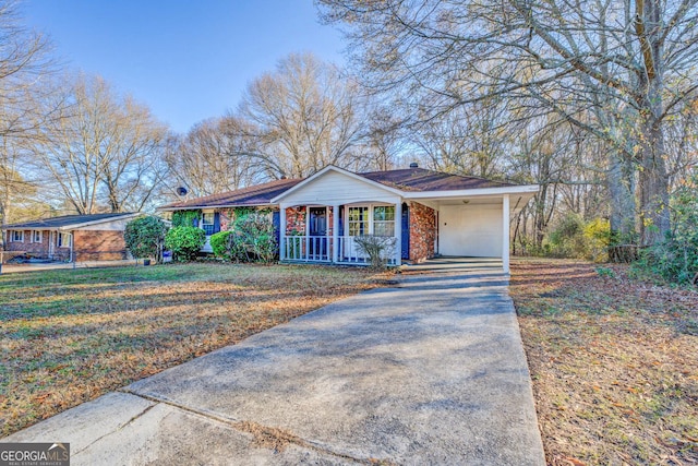 ranch-style home with a front lawn, covered porch, and a carport