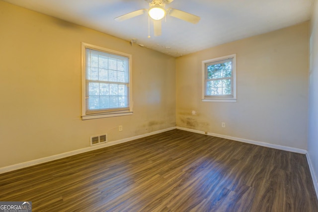 spare room with ceiling fan and dark hardwood / wood-style flooring