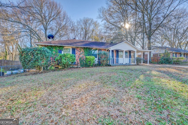 single story home featuring covered porch and a front yard