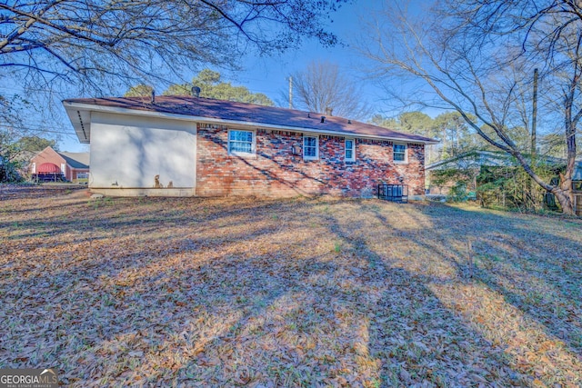 rear view of property with cooling unit