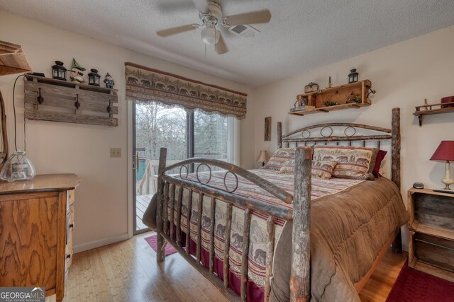 bedroom with light hardwood / wood-style floors and a textured ceiling