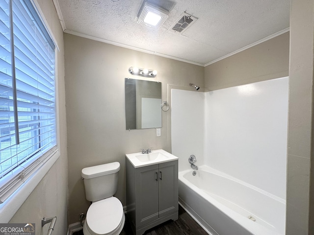 full bathroom with bathtub / shower combination, a textured ceiling, vanity, hardwood / wood-style flooring, and toilet