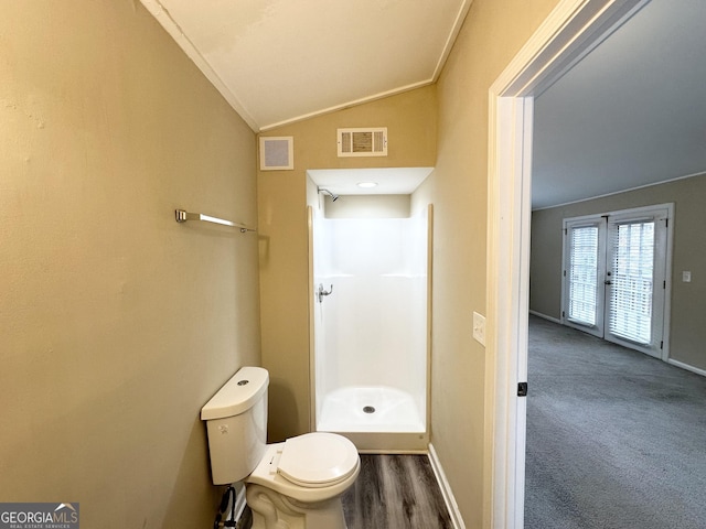 bathroom featuring a shower, lofted ceiling, french doors, toilet, and ornamental molding