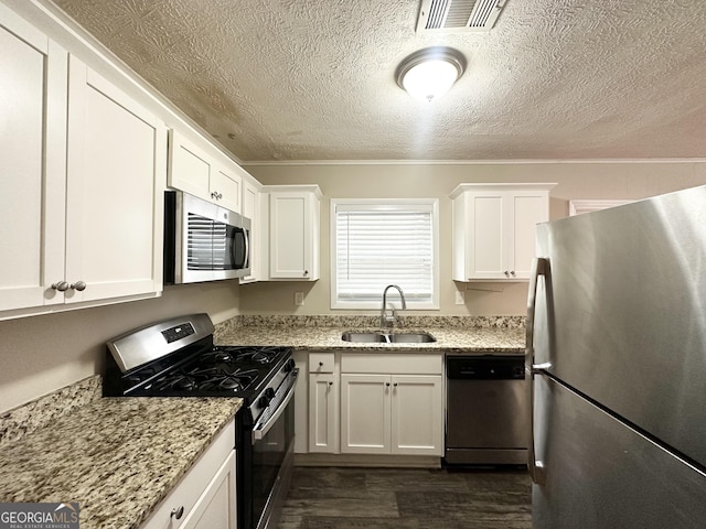 kitchen with white cabinets, sink, and stainless steel appliances