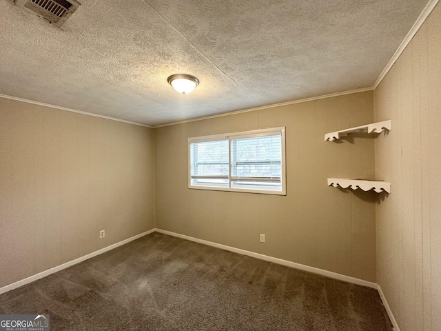 carpeted empty room with crown molding and a textured ceiling