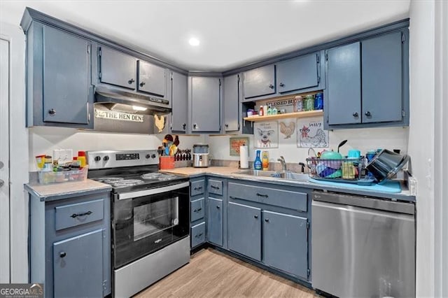 kitchen with stainless steel appliances, light hardwood / wood-style floors, and sink