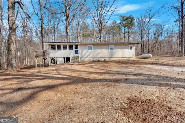 back of property with a wooden deck