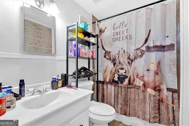 bathroom with vanity, toilet, and walk in shower