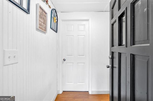 corridor with light hardwood / wood-style floors