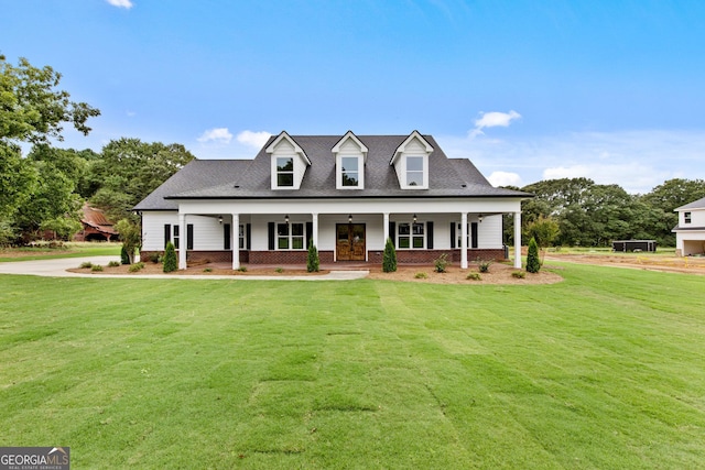 cape cod-style house with a front yard