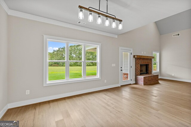 unfurnished living room featuring light hardwood / wood-style floors, crown molding, and a fireplace