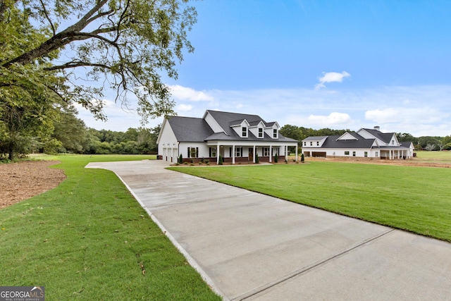 cape cod home featuring a porch and a front yard