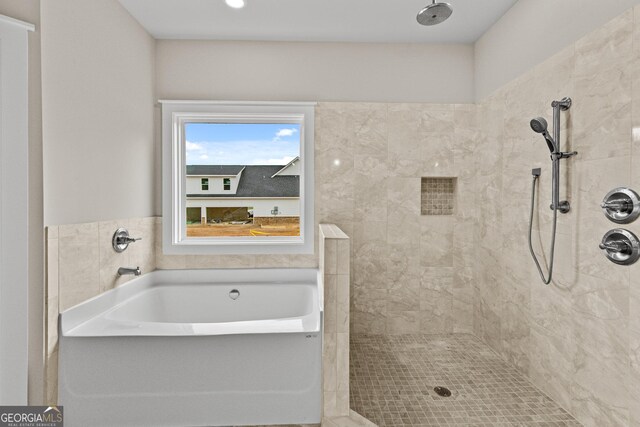 bathroom featuring separate shower and tub