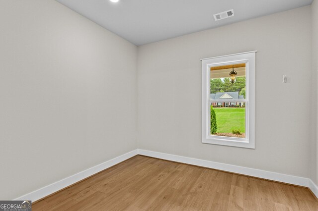 spare room with light wood-type flooring