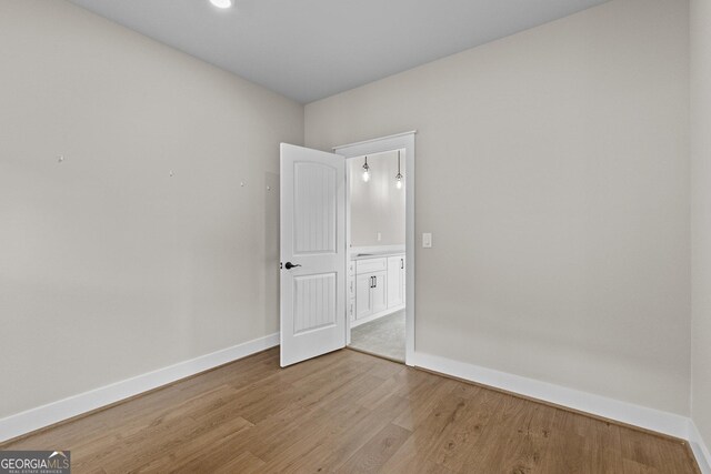 unfurnished room with light wood-type flooring