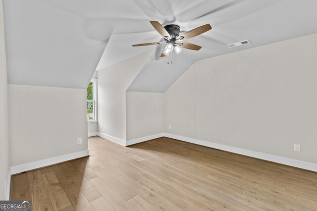 additional living space with ceiling fan, lofted ceiling, and light hardwood / wood-style flooring