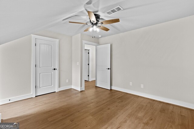 additional living space with light wood-type flooring, vaulted ceiling, and ceiling fan