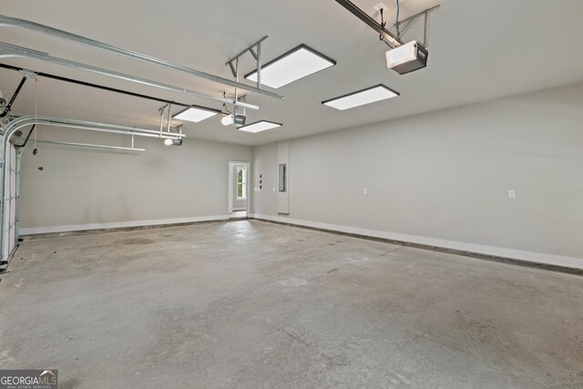 garage featuring electric panel and a garage door opener