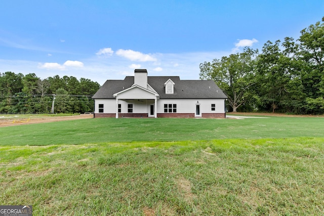 rear view of property with a lawn