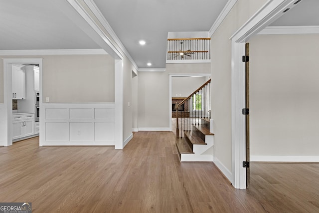 entryway featuring light hardwood / wood-style floors and ornamental molding