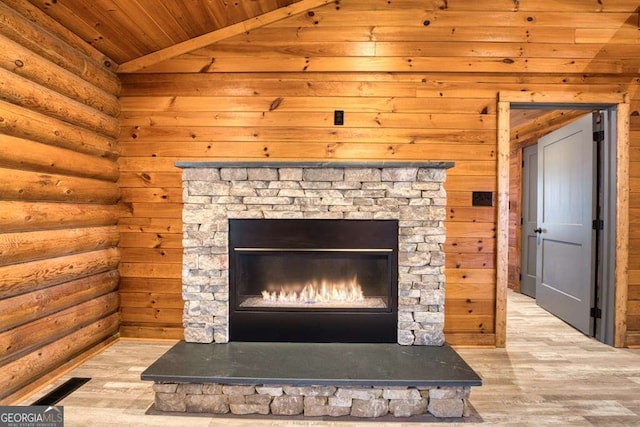 details featuring hardwood / wood-style flooring, a stone fireplace, rustic walls, and wood ceiling