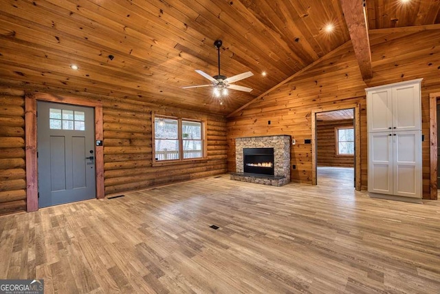 unfurnished living room featuring high vaulted ceiling, wooden ceiling, light wood-style flooring, a fireplace, and log walls