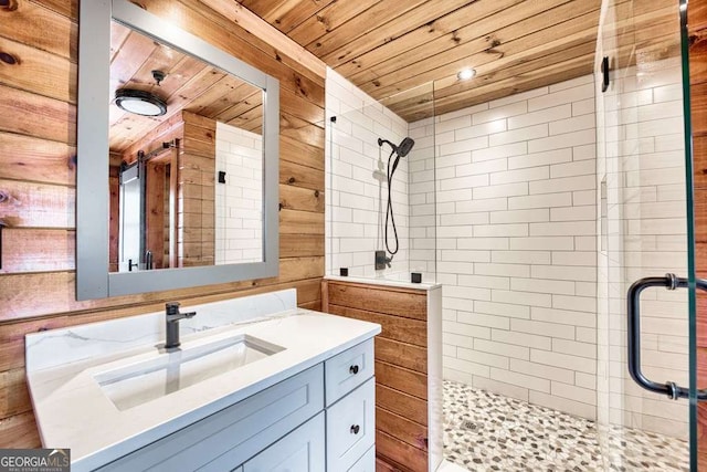 bathroom with wooden ceiling, a shower stall, wooden walls, and vanity