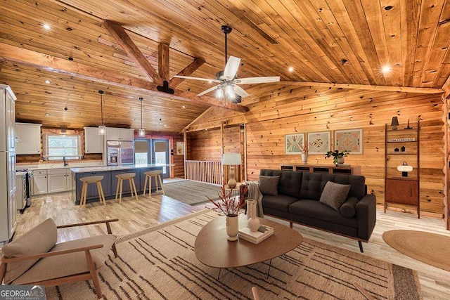 living room featuring light wood-type flooring, wooden walls, wooden ceiling, and sink