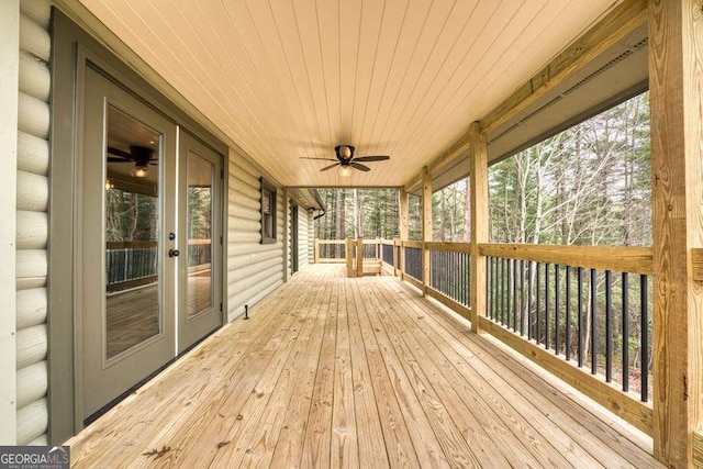 wooden deck featuring a ceiling fan and french doors