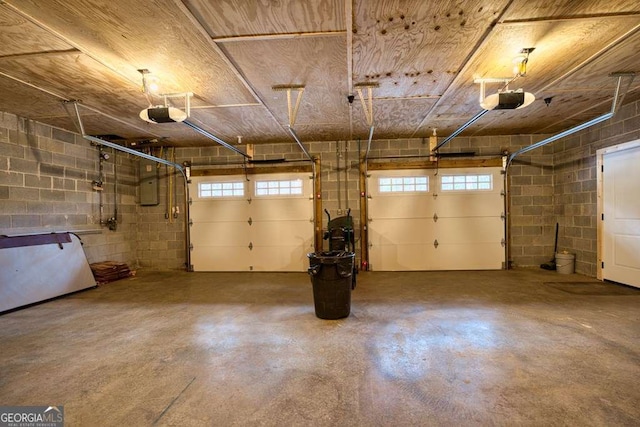 garage featuring electric panel, wood ceiling, and a garage door opener