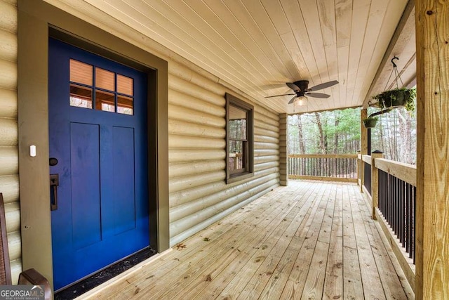 wooden terrace featuring ceiling fan and a porch