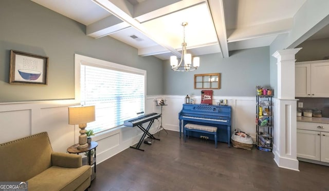 misc room with beam ceiling, ornate columns, dark wood-type flooring, and an inviting chandelier