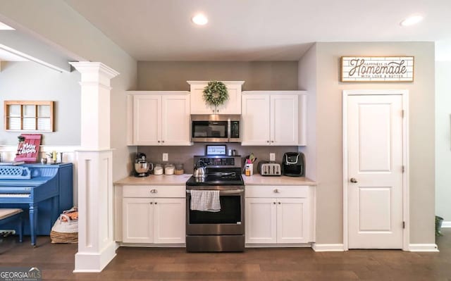 kitchen featuring dark hardwood / wood-style flooring, stainless steel appliances, and white cabinetry