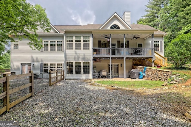 rear view of house featuring ceiling fan