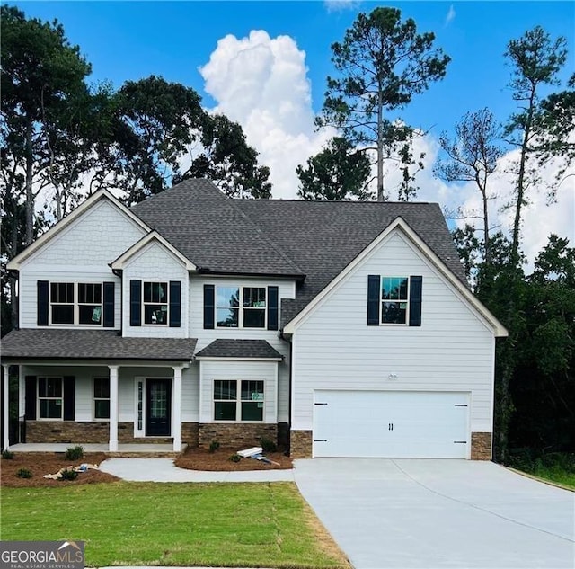 view of front of house with a front yard and a garage