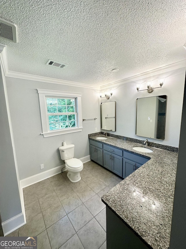 bathroom featuring tile patterned flooring, vanity, a textured ceiling, and ornamental molding