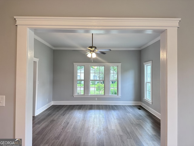 spare room featuring ceiling fan, crown molding, a healthy amount of sunlight, and dark hardwood / wood-style floors