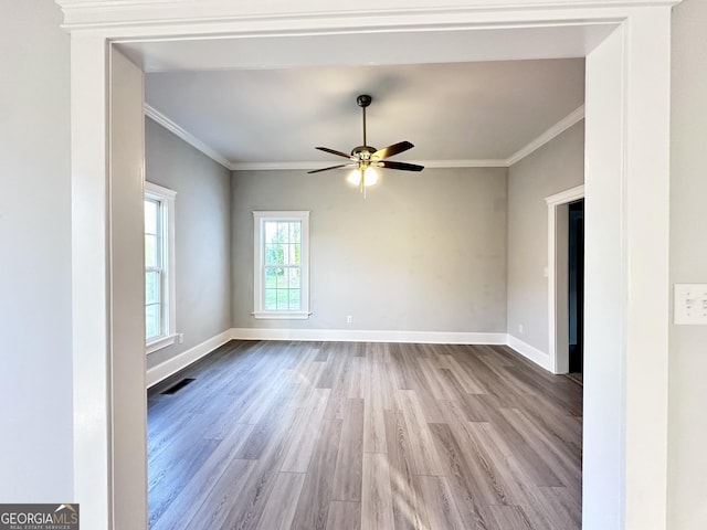 unfurnished room with light wood-type flooring, ceiling fan, and crown molding