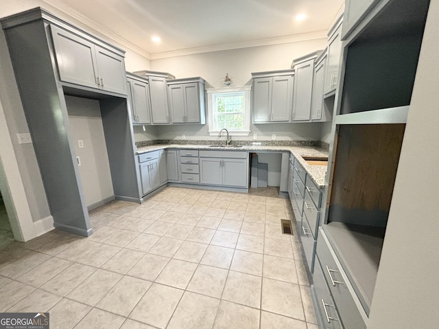 kitchen featuring light stone countertops, sink, gray cabinets, light tile patterned floors, and ornamental molding