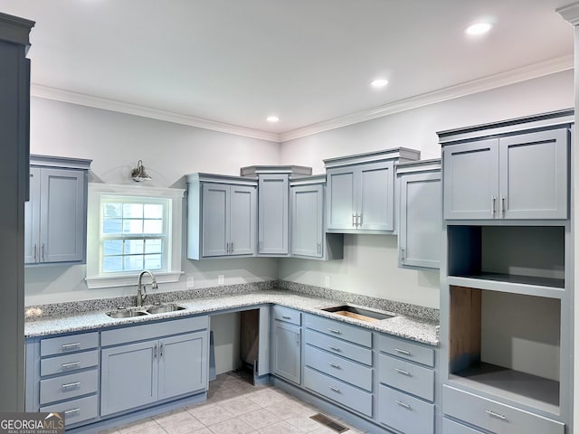 kitchen with light tile patterned flooring, ornamental molding, and sink