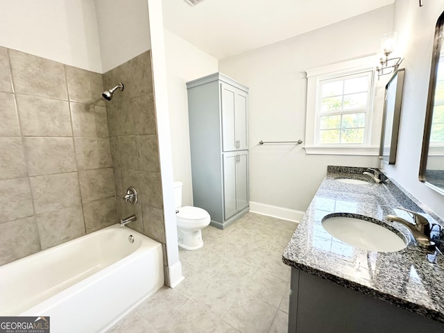 full bathroom featuring tile patterned floors, vanity, toilet, and tiled shower / bath combo