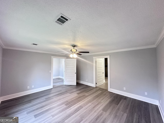 unfurnished bedroom featuring ceiling fan, dark wood-type flooring, a textured ceiling, and ornamental molding