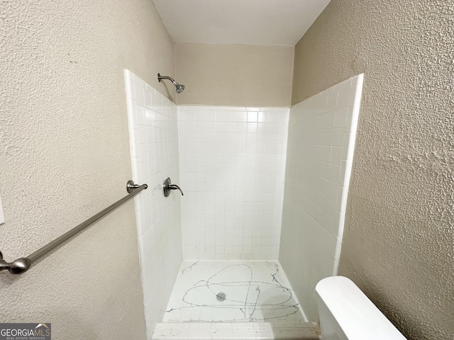 bathroom with a tile shower